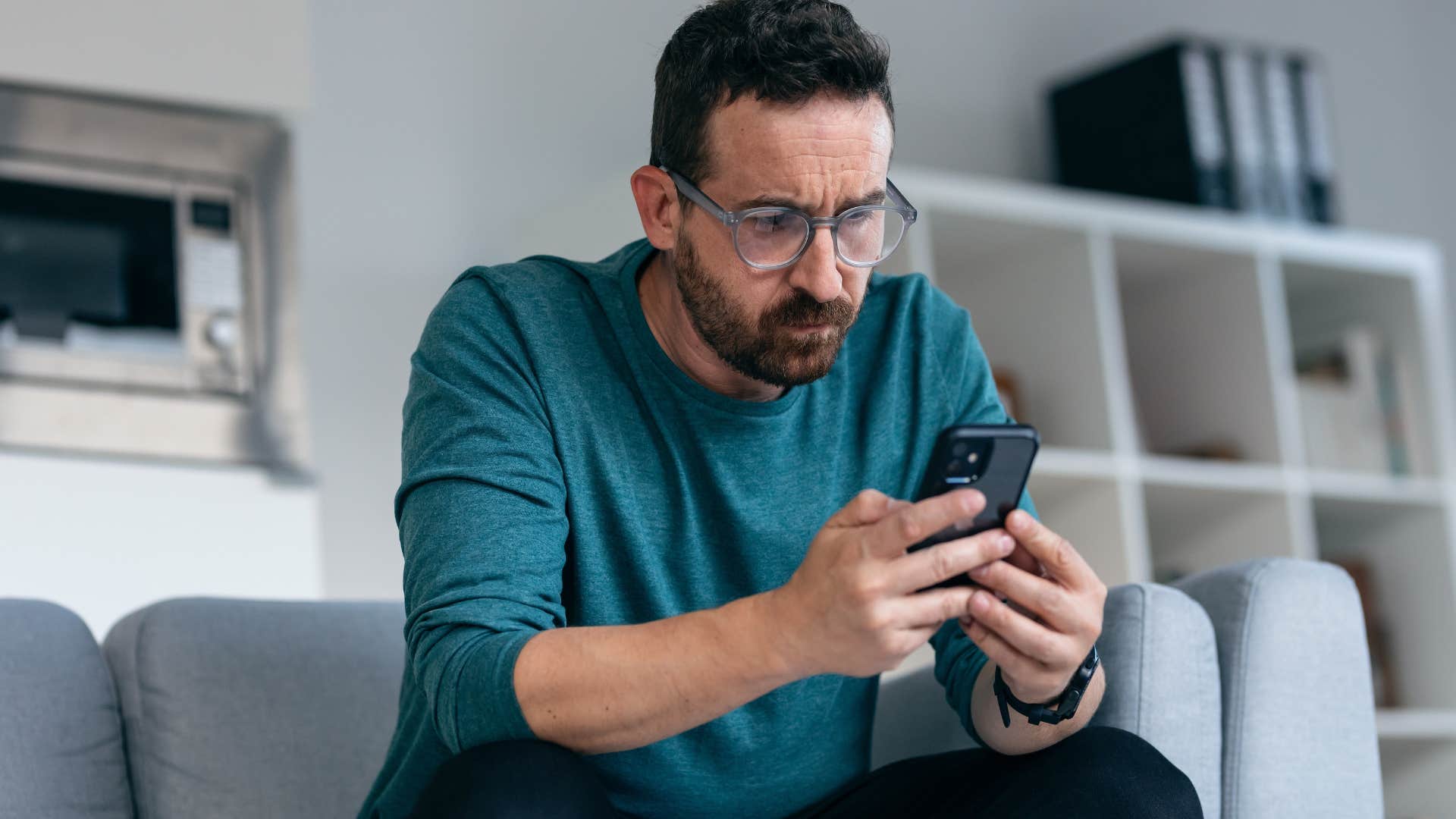 man staying grounded looking at phone