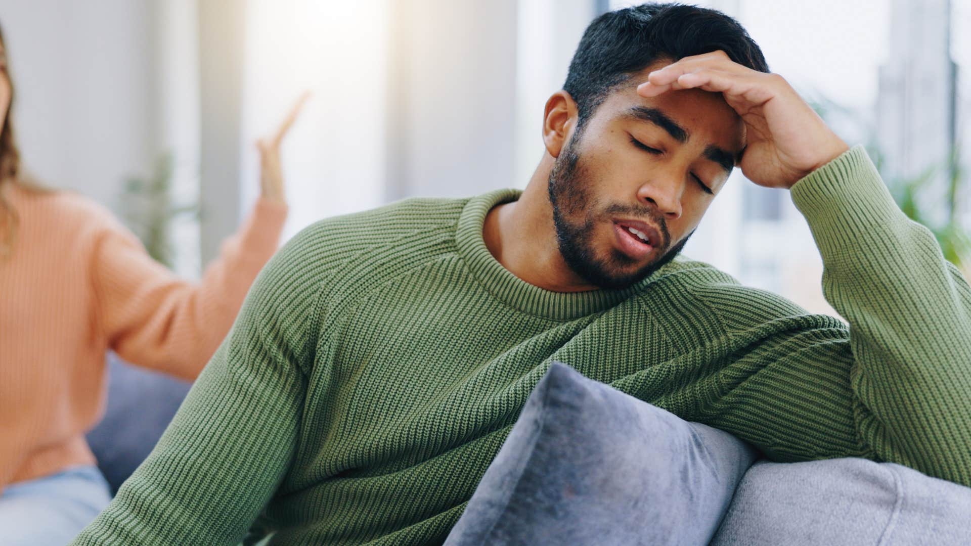 man getting defensive in argument with his wife