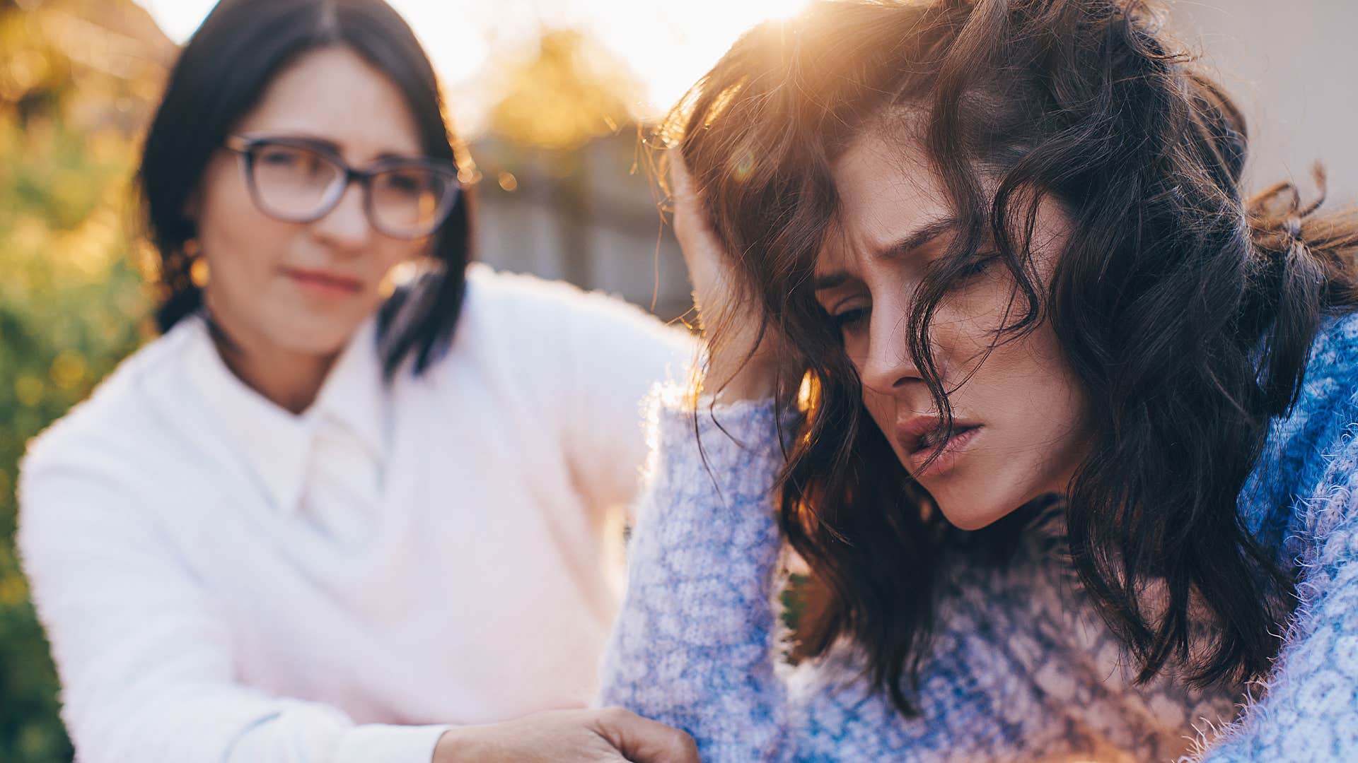 woman comforting friend during tense conversation