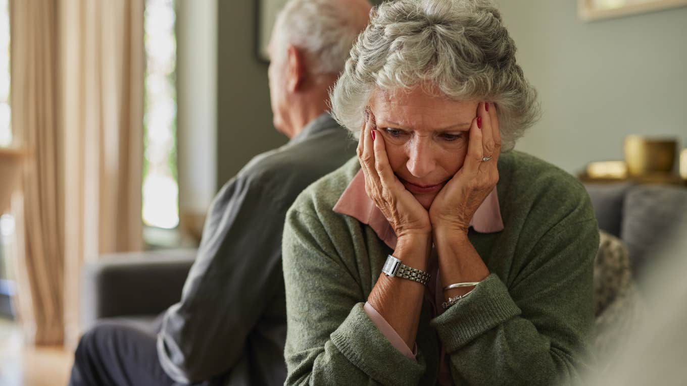 upset older woman sitting with back turned to husband