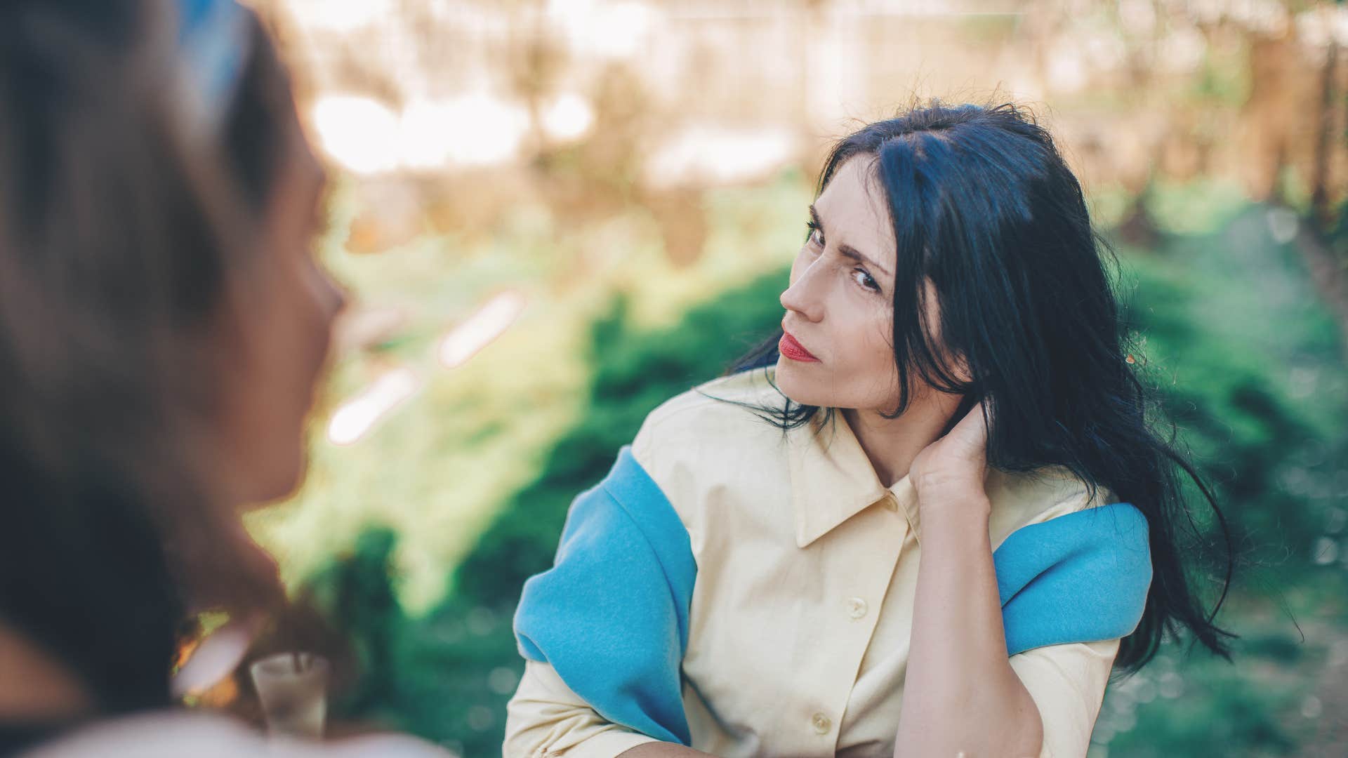 rude woman looking confused saying i'm surprised you didn't know that to friend