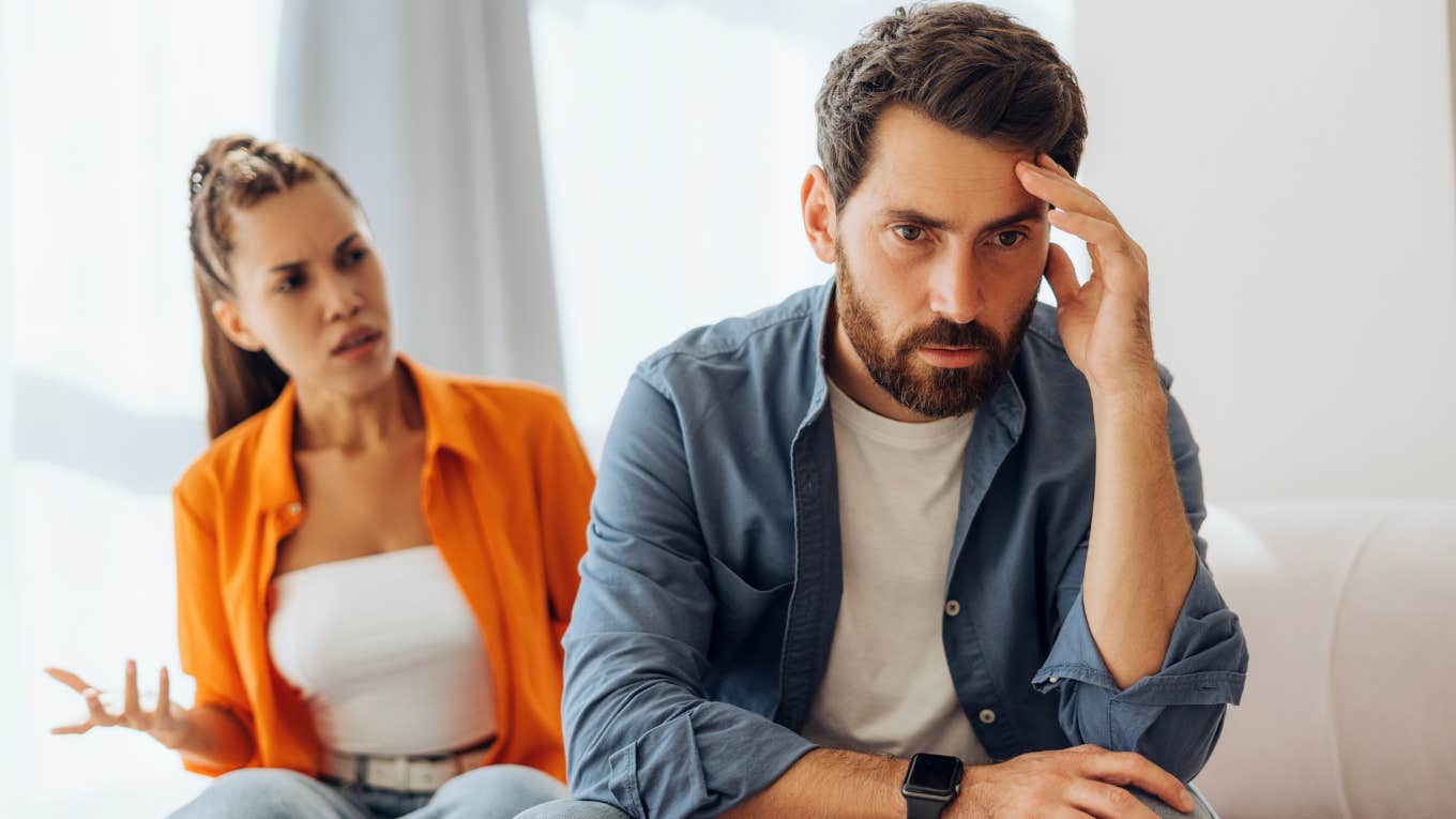woman yelling at tired husband
