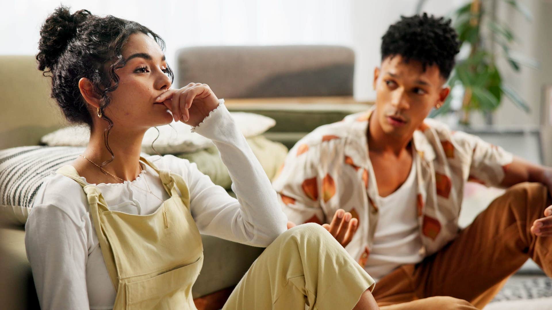woman upset and thinking he takes me for granted as man looks at her on floor