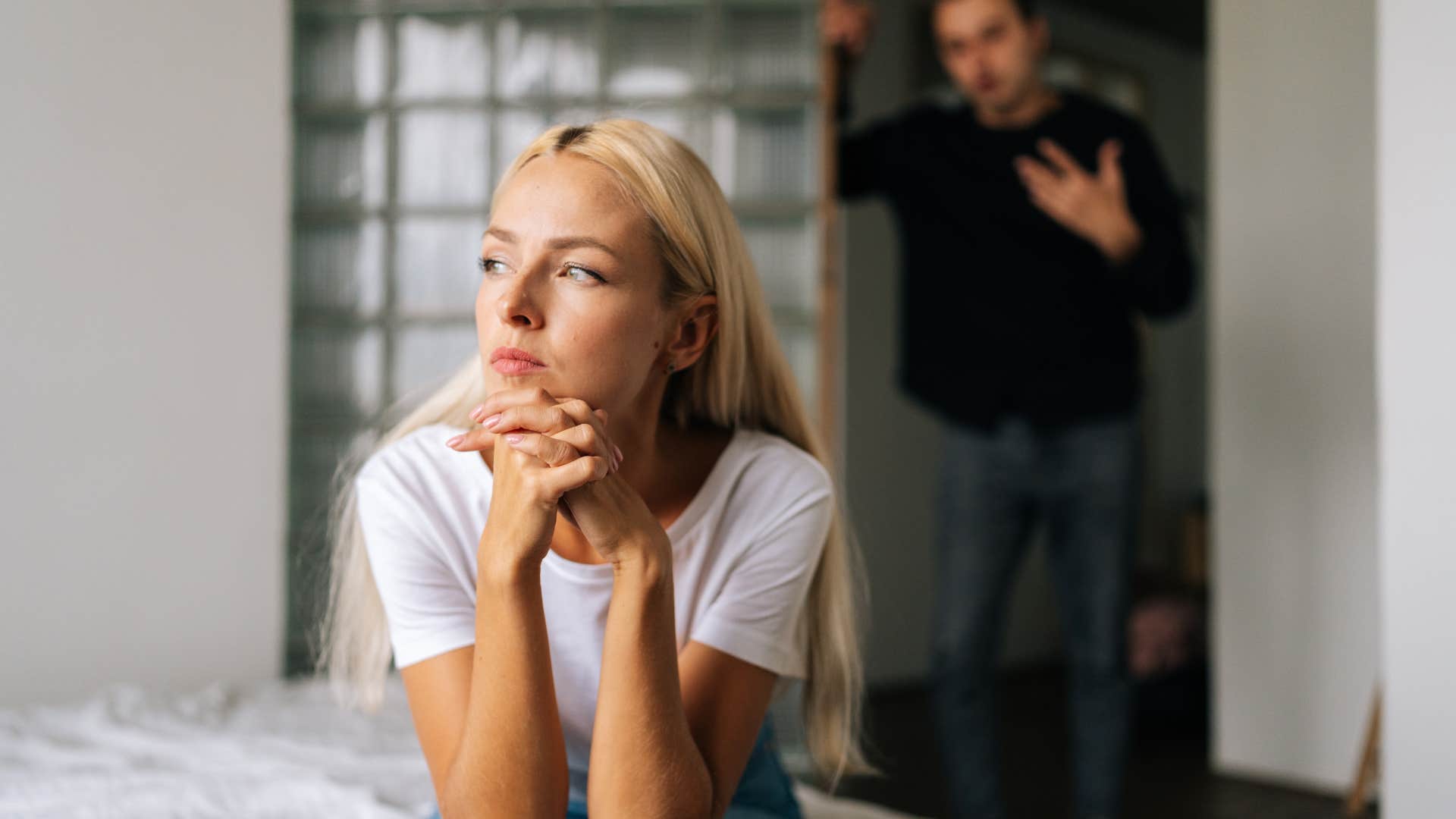 woman in white shirt ignoring man as she thinks i don't feel safe opening up to him anymore