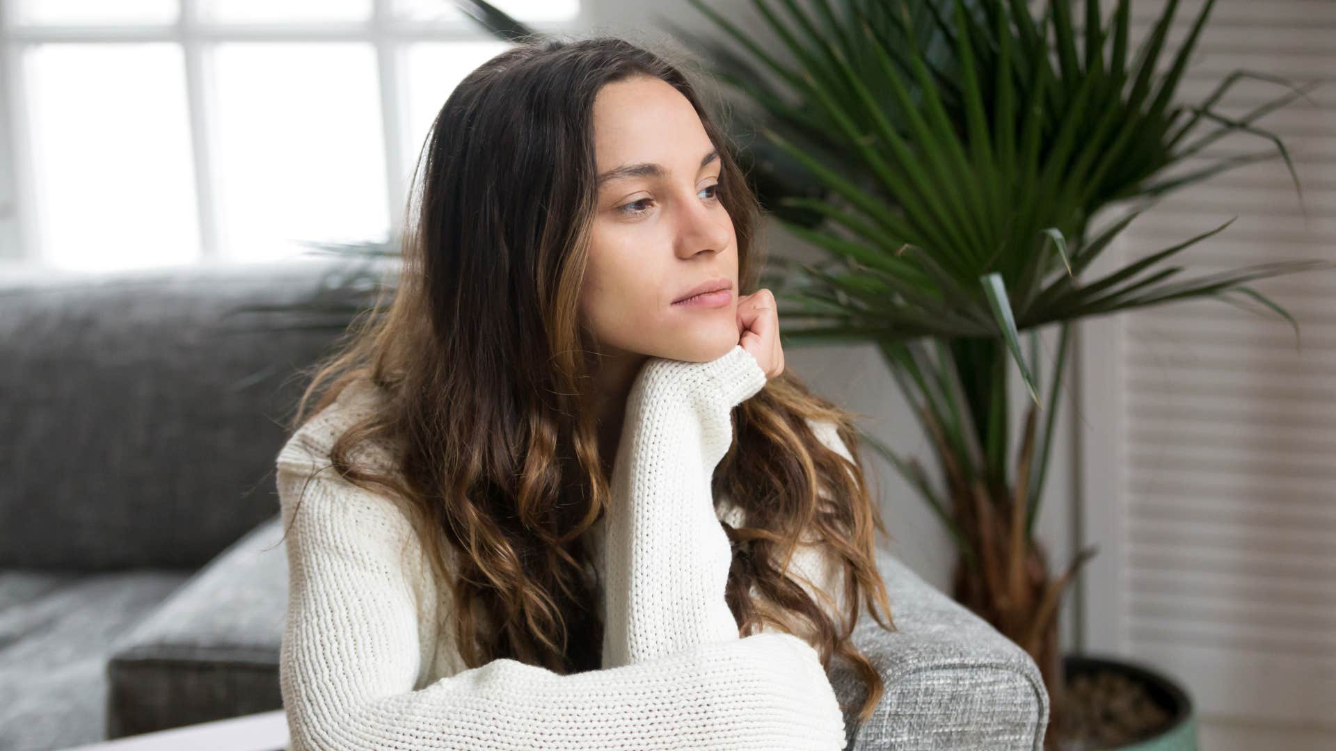 woman in white sweater thinking it feels like he doesn't know me anymore
