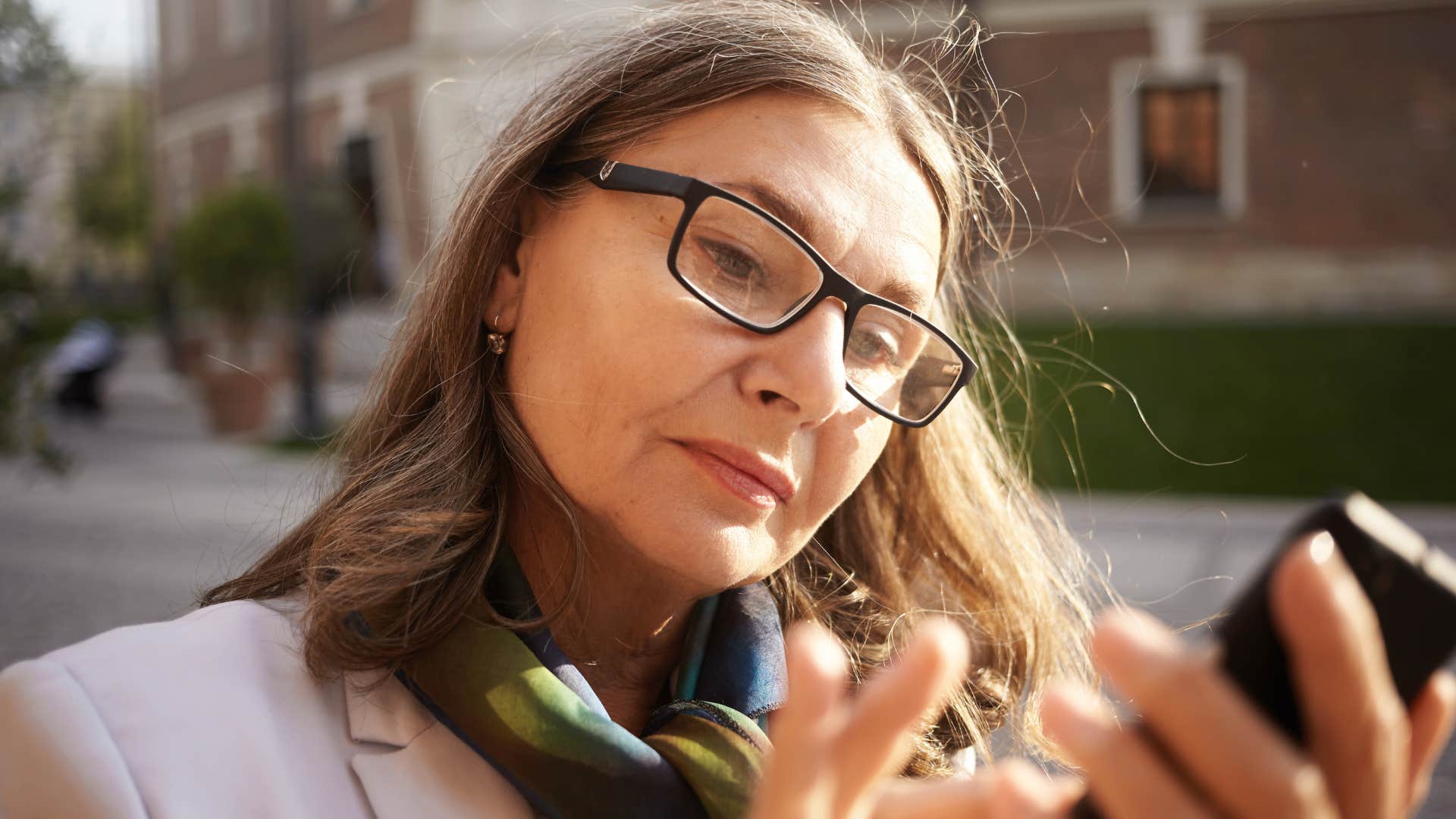 Woman who assumes everything's fine looking at her phone.