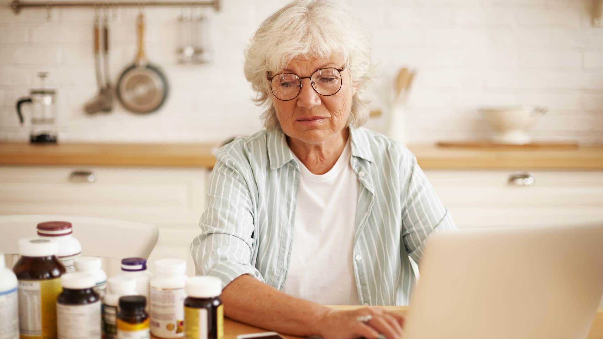 Woman who fears losing control looking at medications at home.