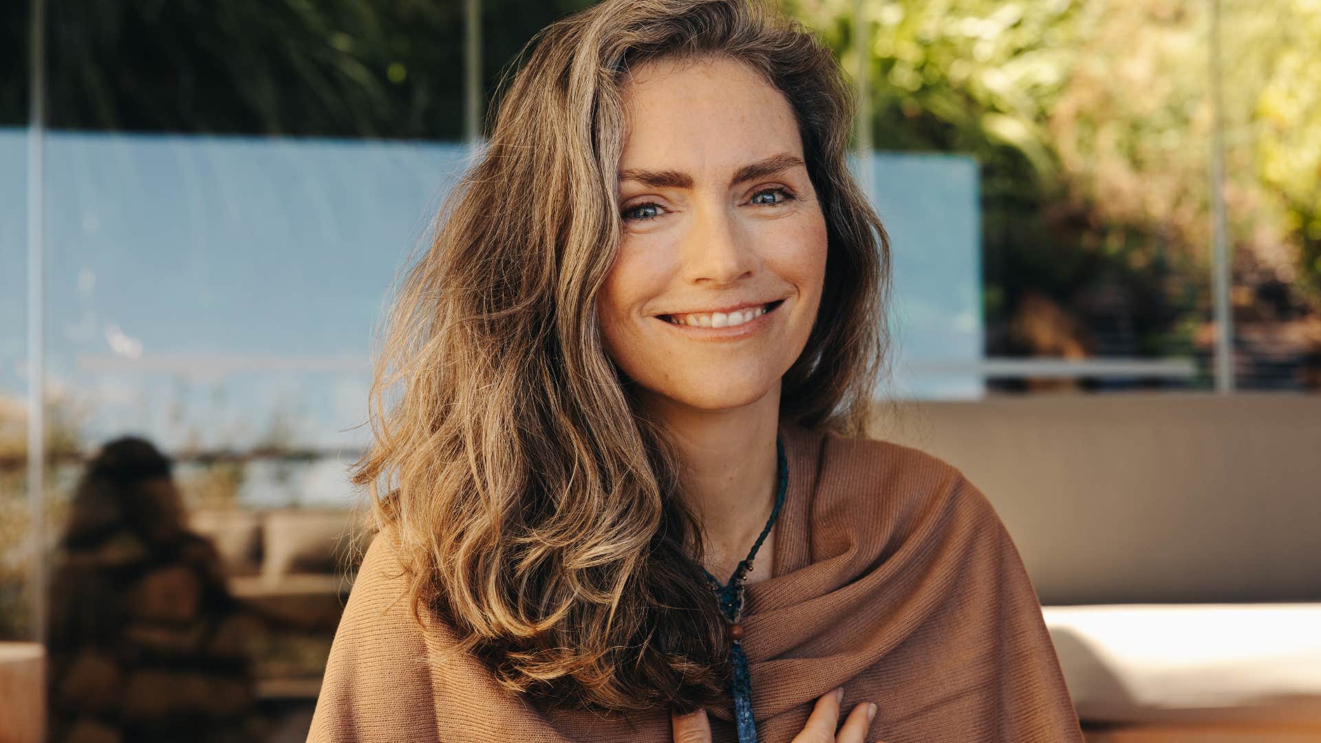 Woman who prefers holistic medicine alternatives smiling at the camera.