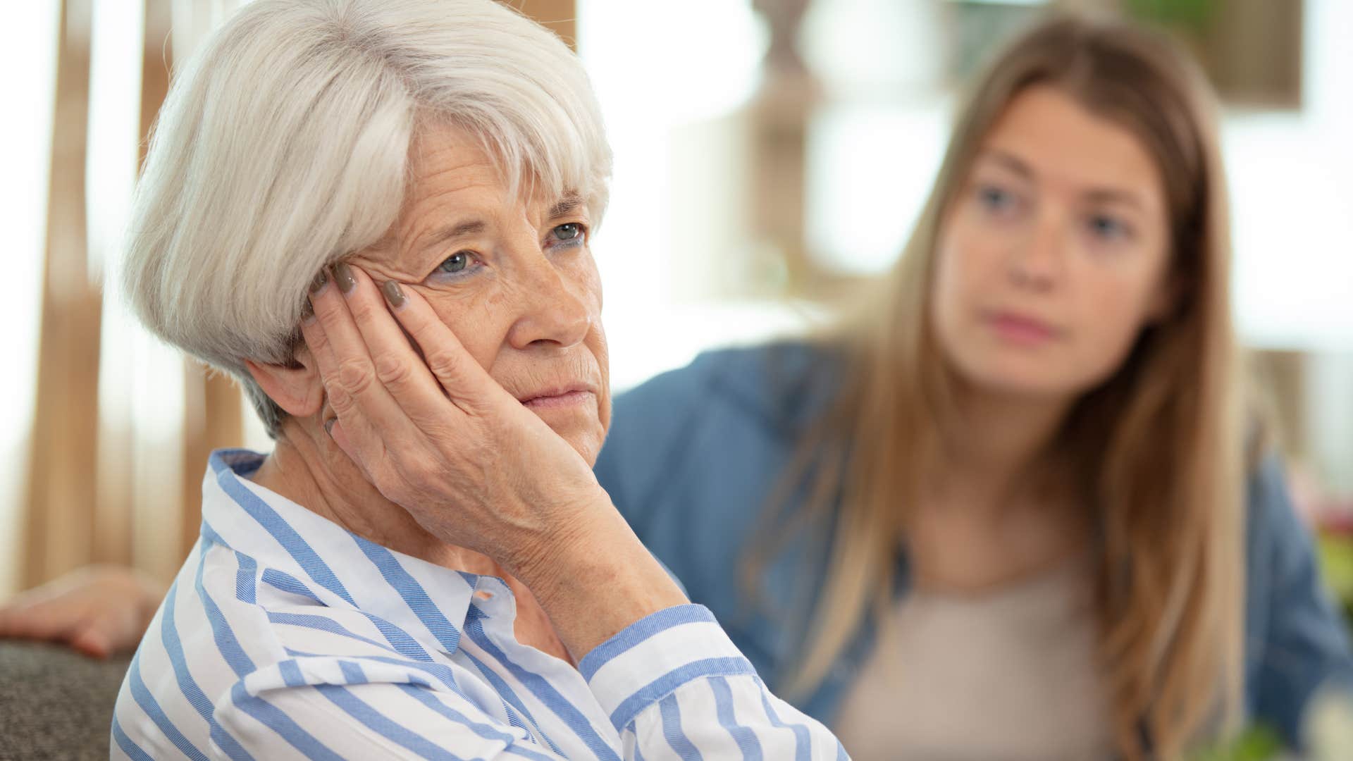 Woman who's uncomfortable talking about certain things turned away from her daughter.