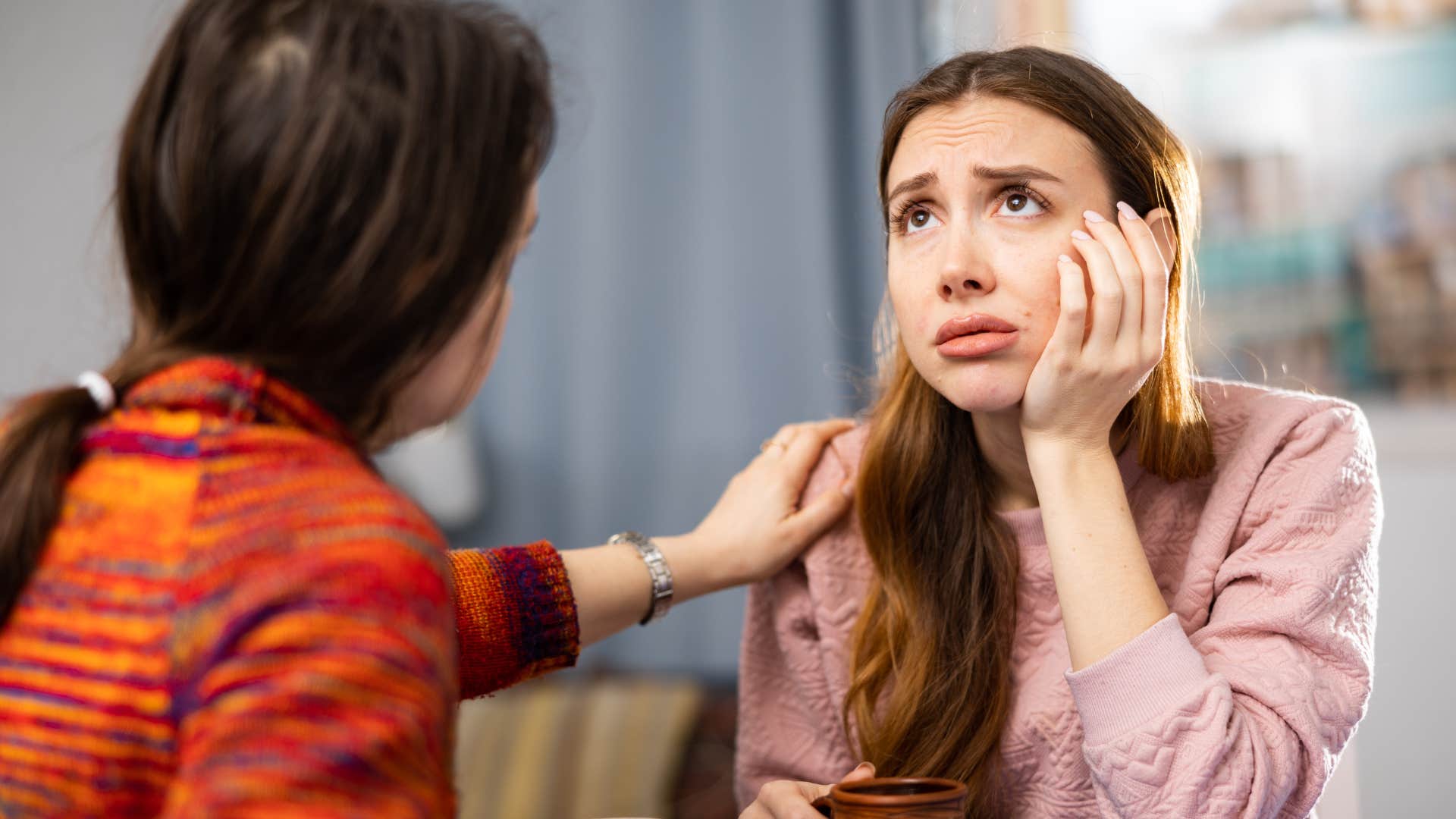 woman crying to friend for sympathy