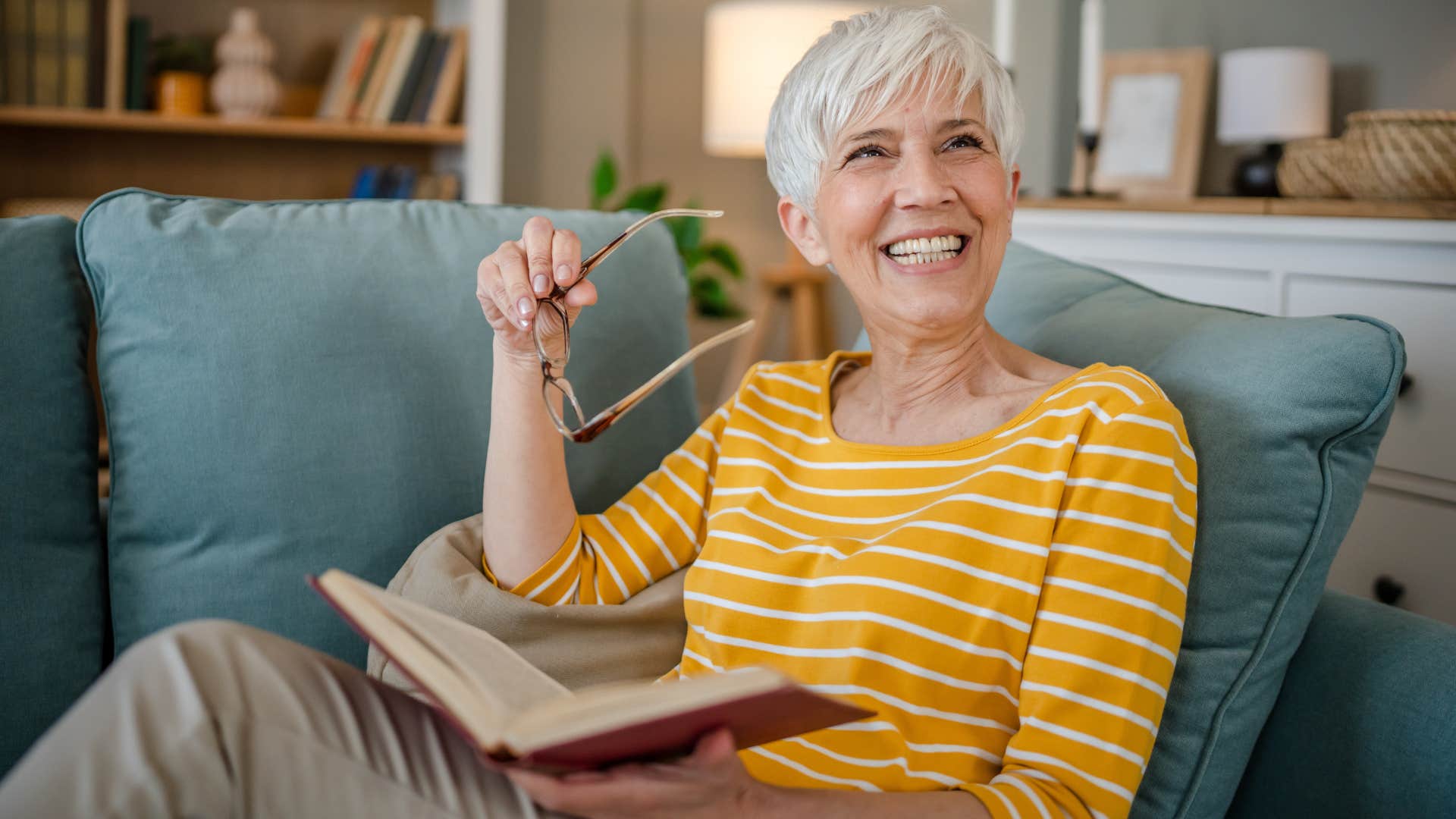 woman who's embraced a slower pace of life reading at home