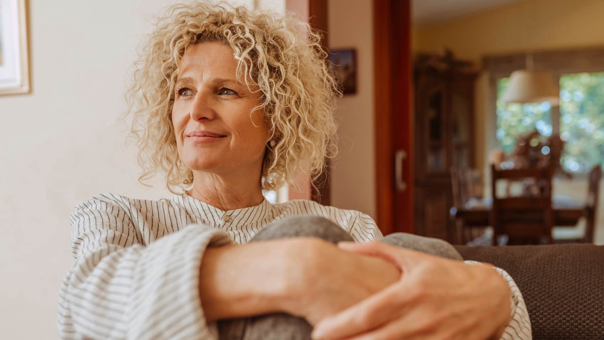 older woman appreciating her own company sitting at home