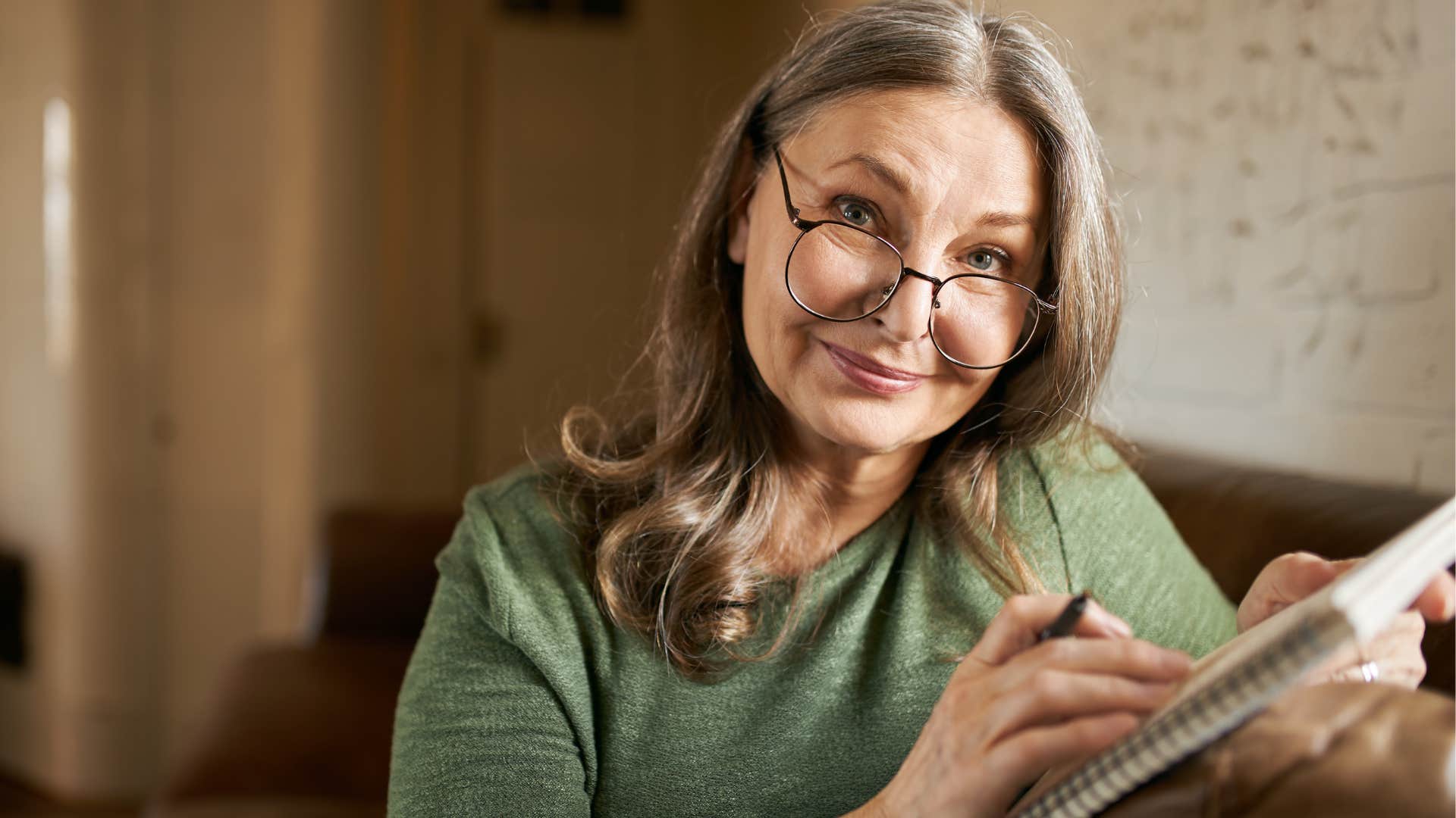 older woman with fulfilling hobbies writing