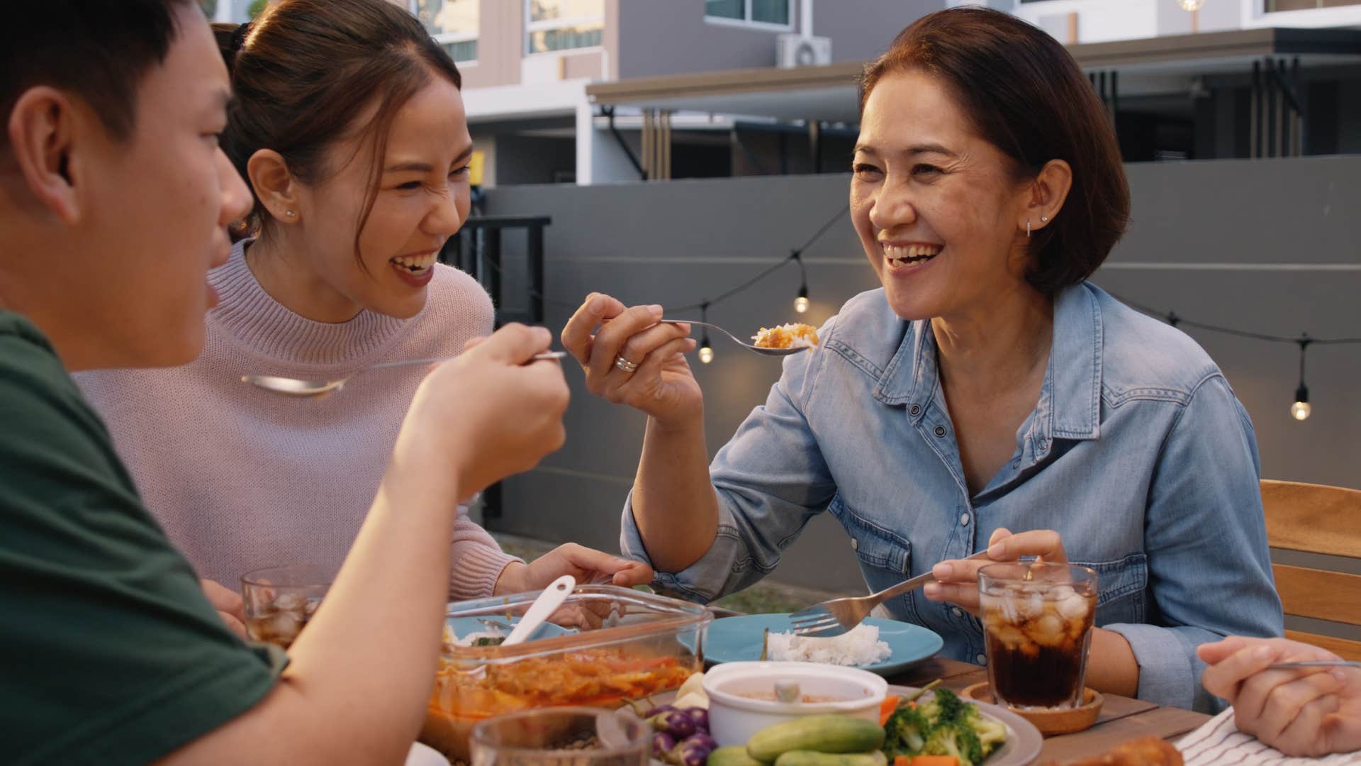 woman enjoying being comfortable sitting at dinner with her family