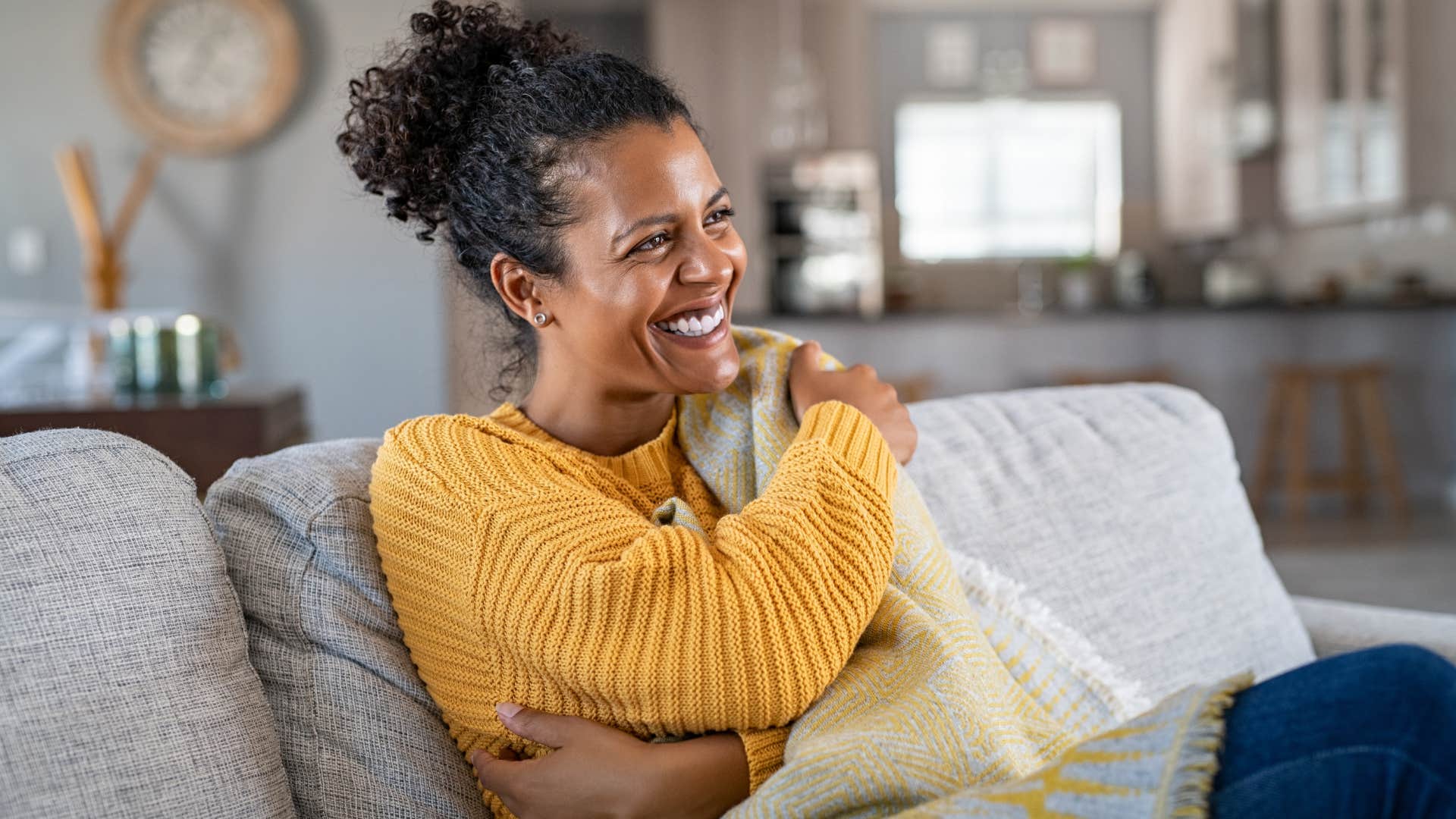 woman who prioritizes their rest sitting on the couch
