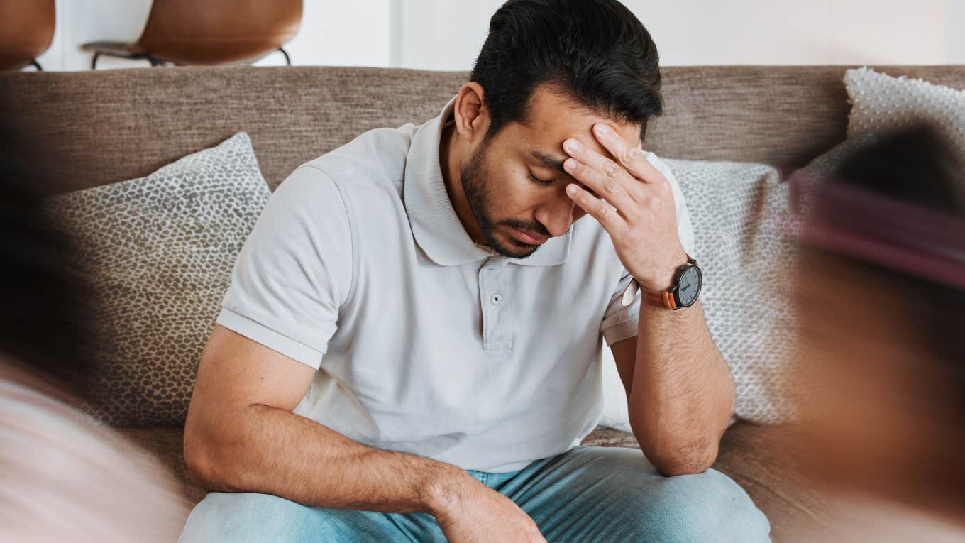 stressed out dad sitting on couch at home