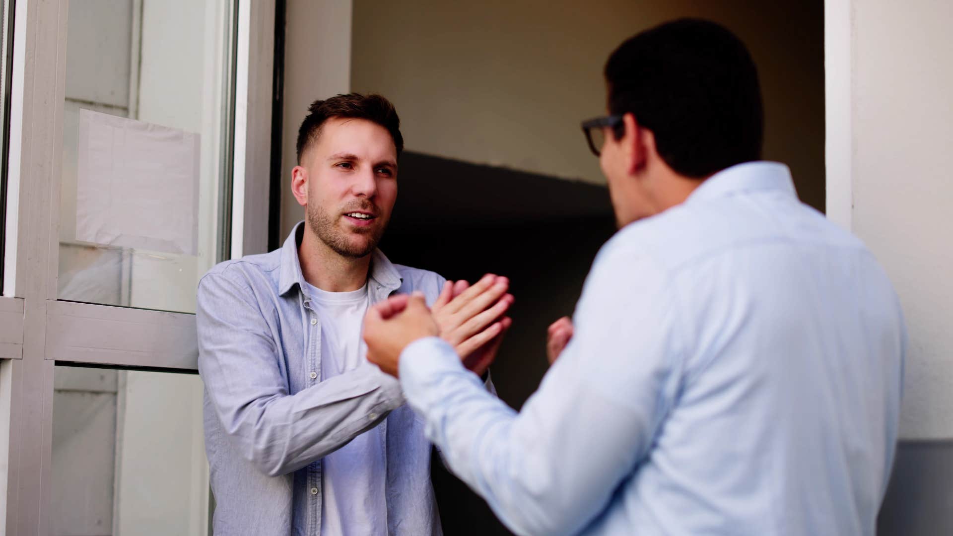 man arguing with friend defending wife