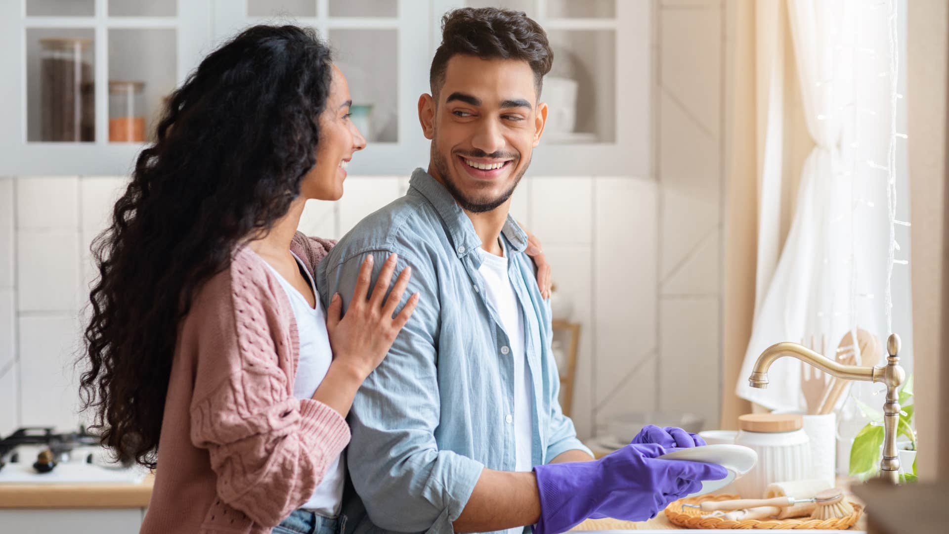 man doing dishes to help wife with chores