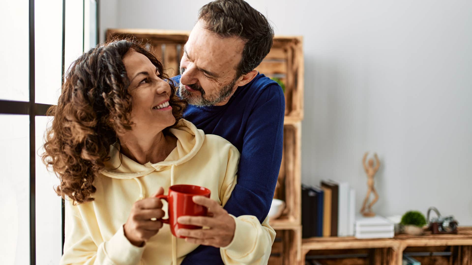 man initiating physical touch hugging his wife