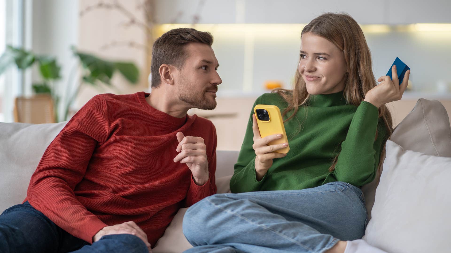 woman hiding credit card from partner to save up and pay cash