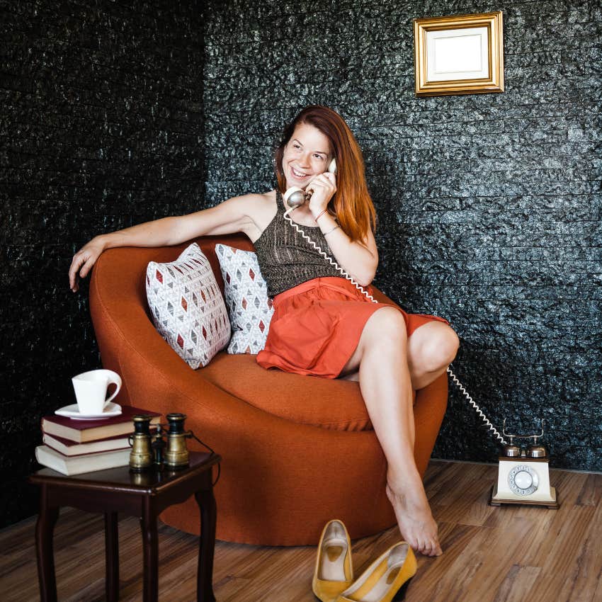 woman using 90s relic landline making comeback