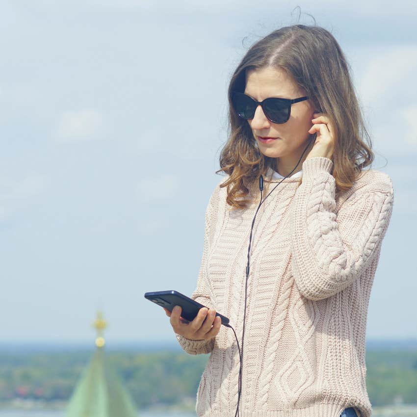 woman using wired headphones 90s relic making comeback