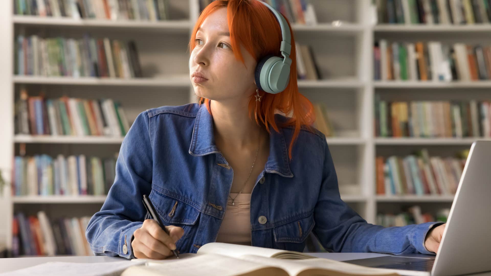 young woman researching at a library