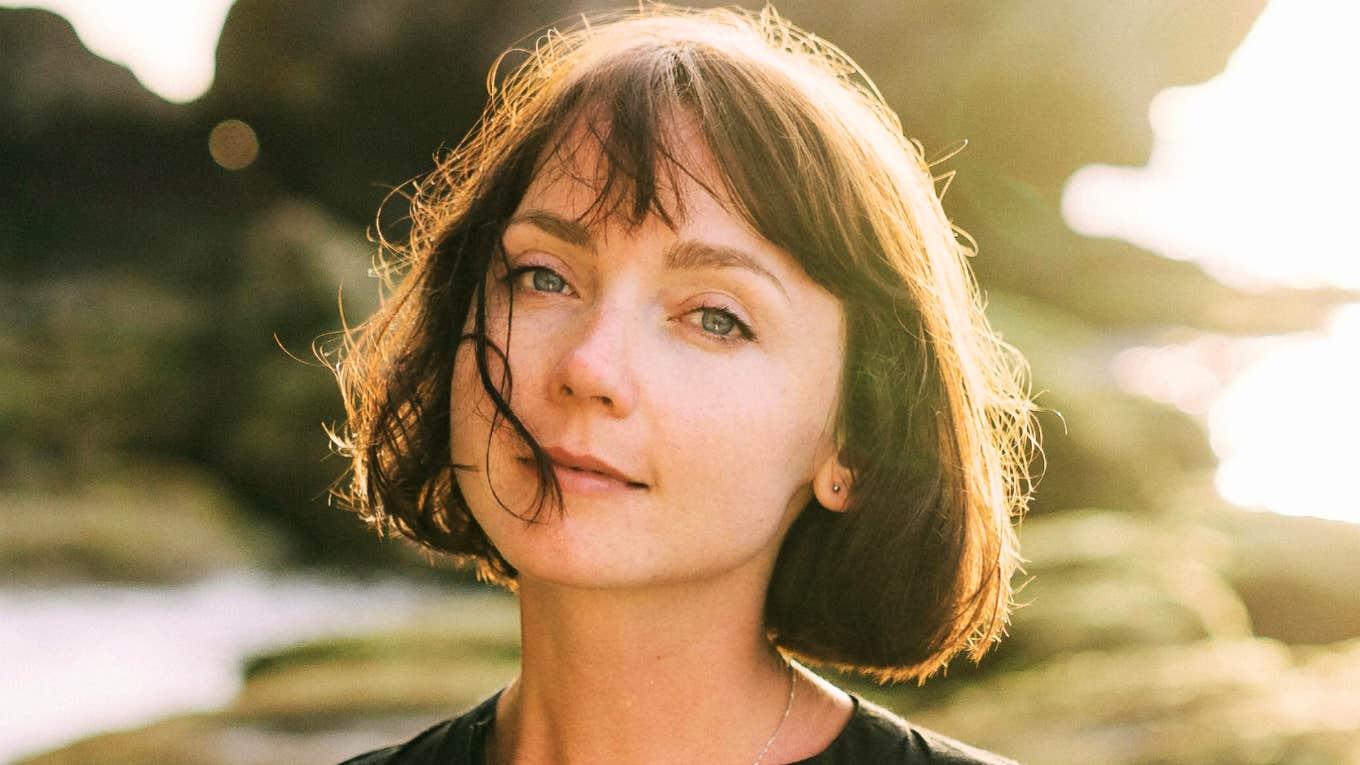 Calm person with a warm smile, showing types of people who naturally heal and uplift everyone around them.