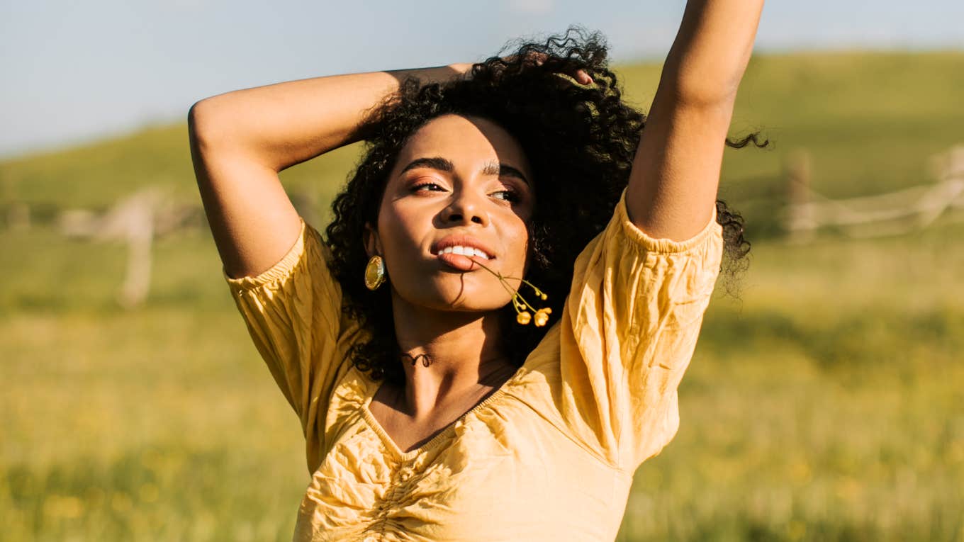 The Art Of Hygge: Simple Ways To Live A Happy, Peaceful Life Woman relaxing on a meadow, illustrating simple ways to embrace hygge and live a happy, peaceful life