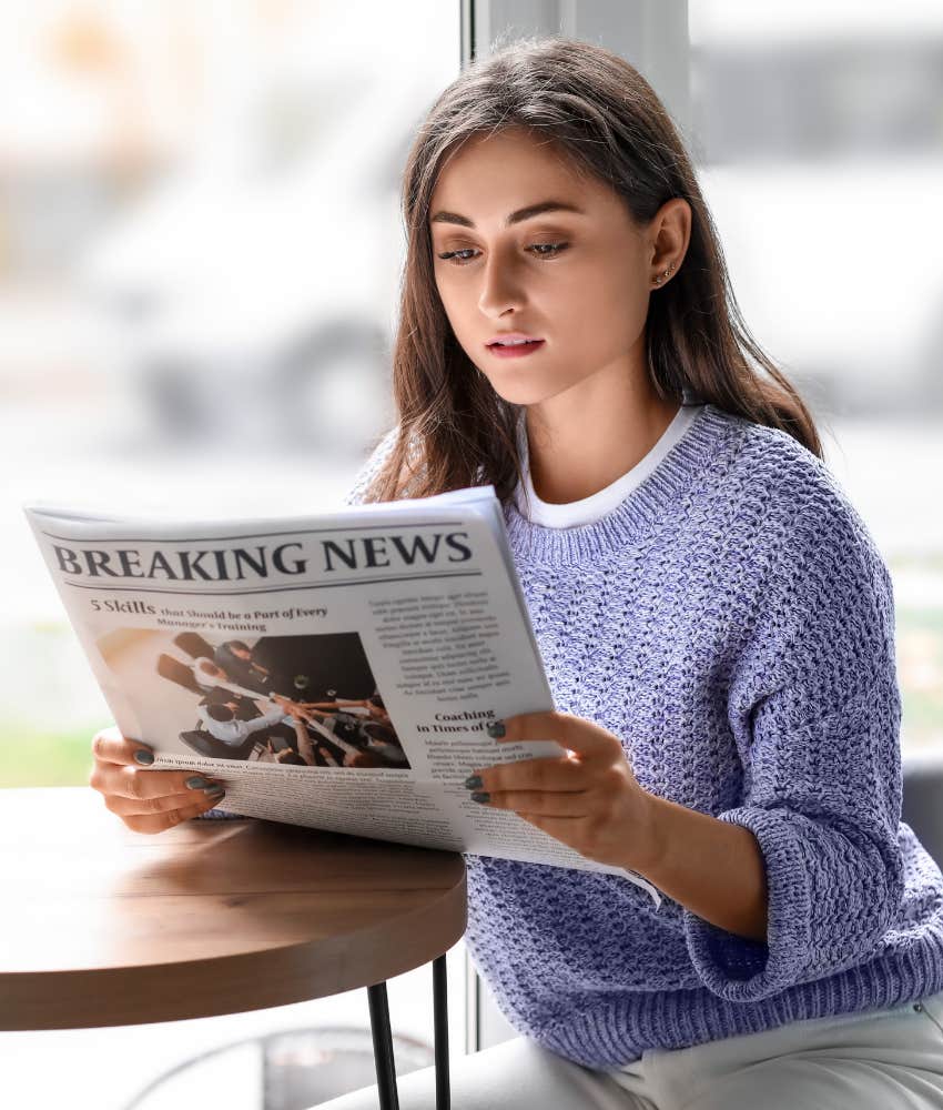 Positive person reads newspaper