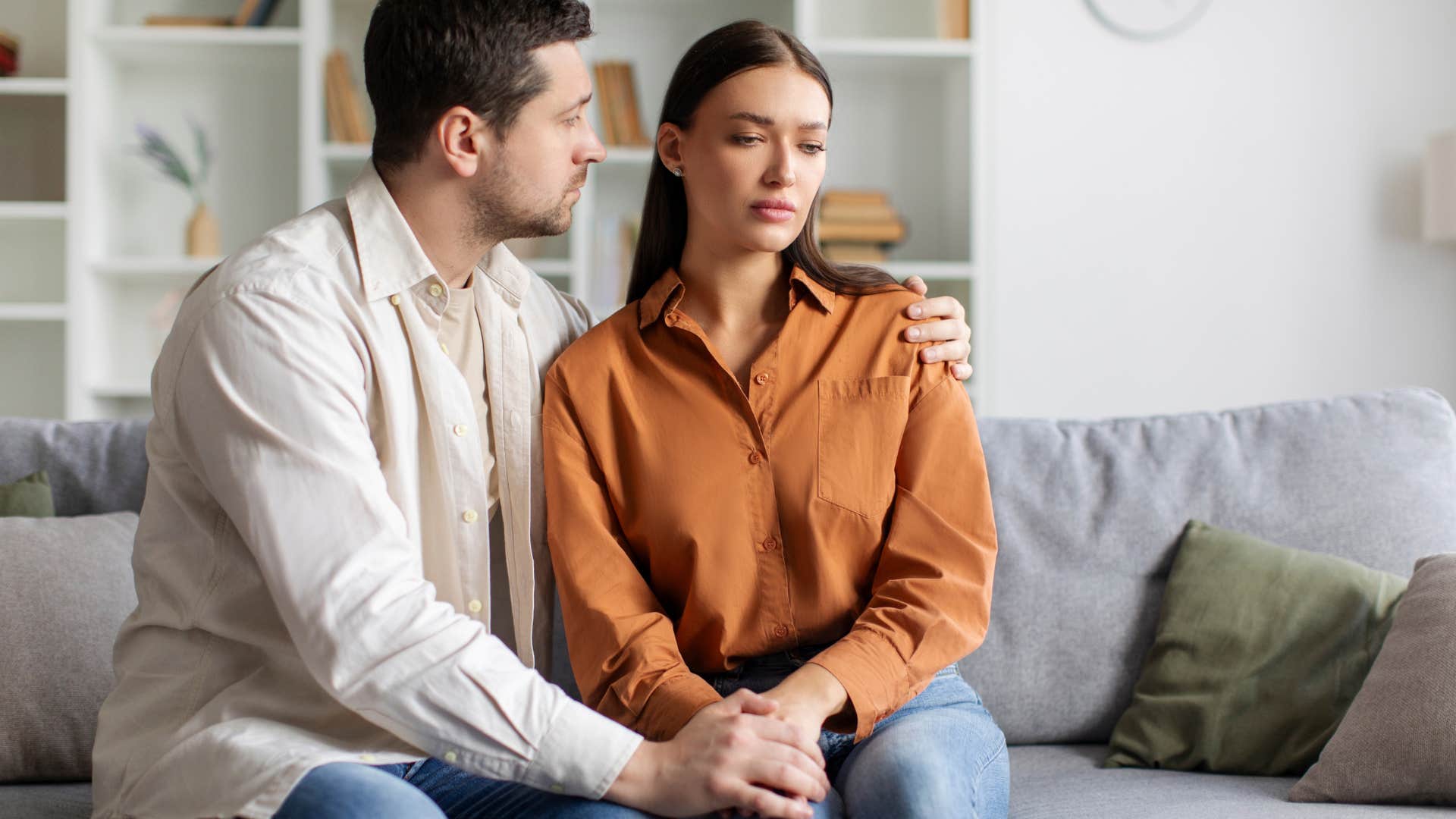 needy woman being comforted by man