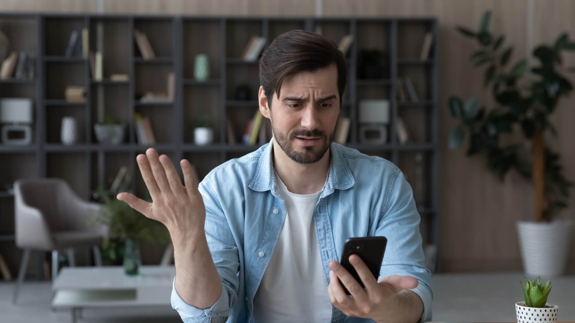 man who is looking at his phone because he needs to know a woman's location