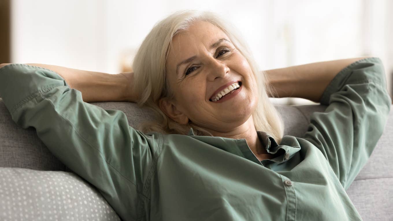 boomer woman smiling relaxing on the couch