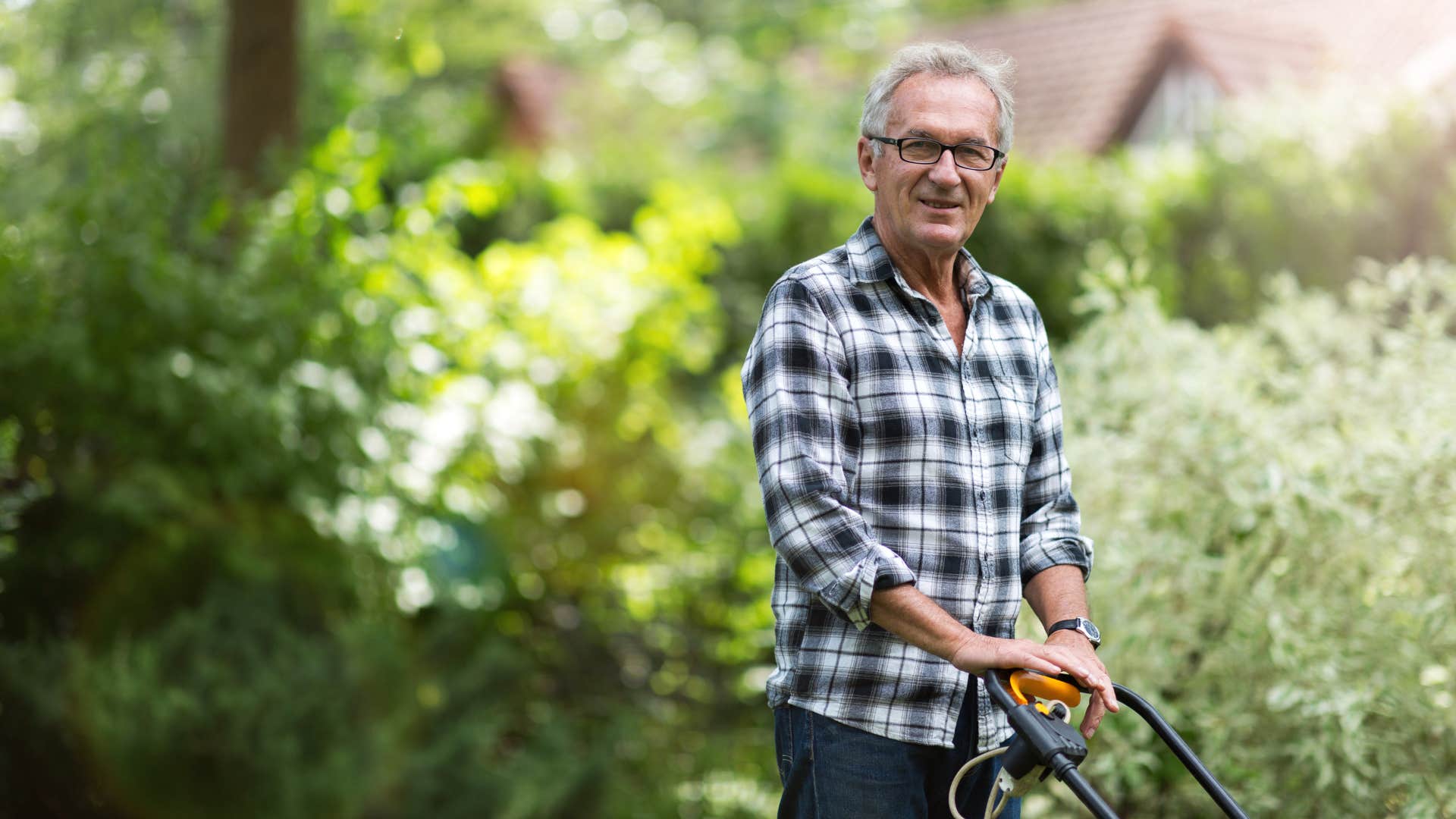 older man mowing the lawn for his neighbors