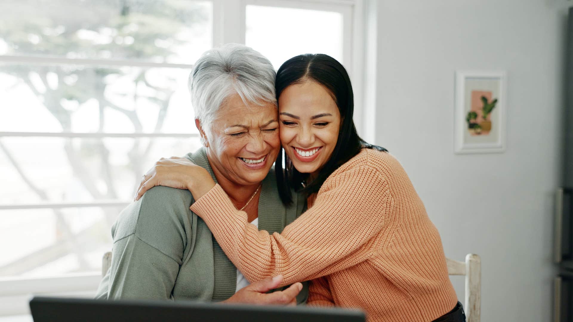 mom and daughter smiling and hugging