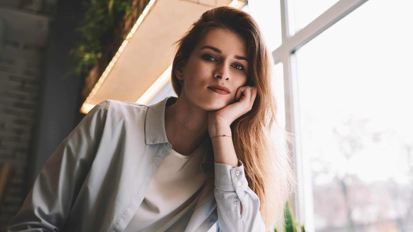 pensive woman sitting in a cafe