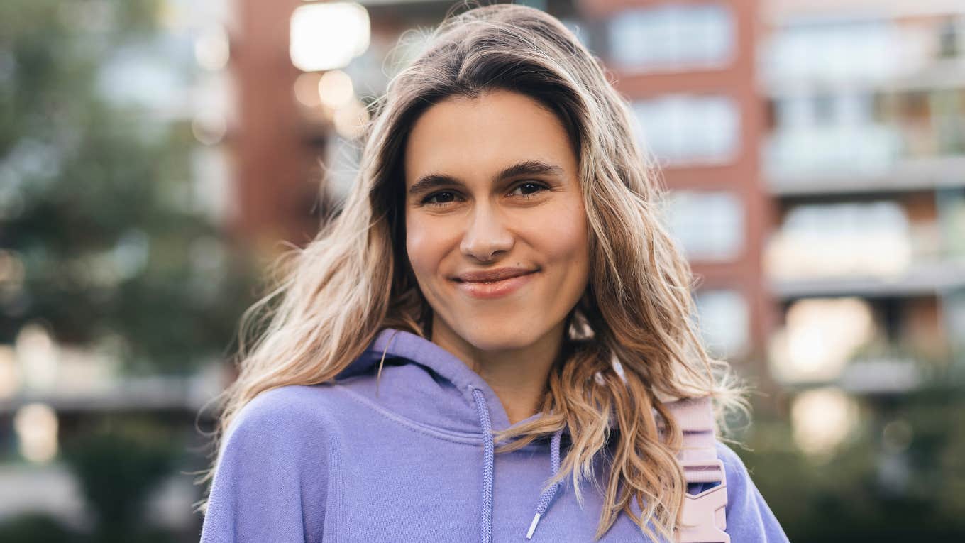authentic young woman smiling outside
