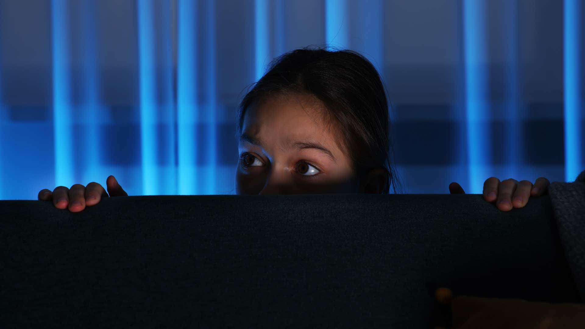 chilling signs a poltergeist is haunting your home feel like being watched woman who has a poltergeist haunting her home as she feels like she's being watched