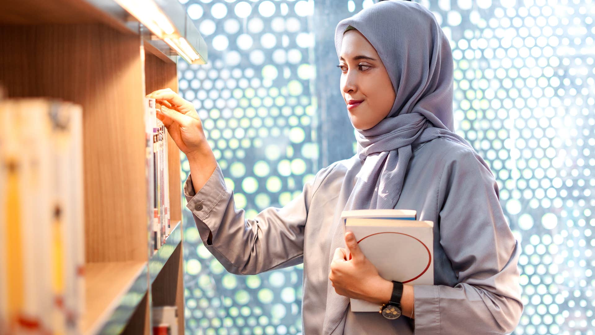 woman picking out book to provide companionship