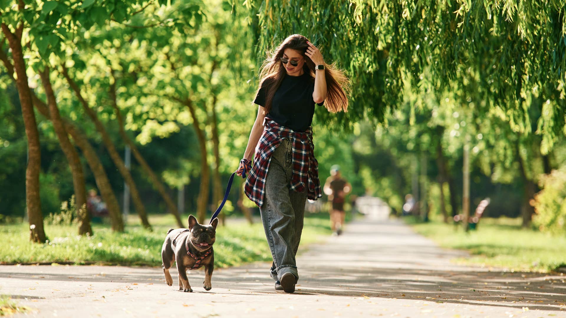 common mistakes that hurt your dog's feelings without you even realizing rushing them through a walk woman walking her dog in the park