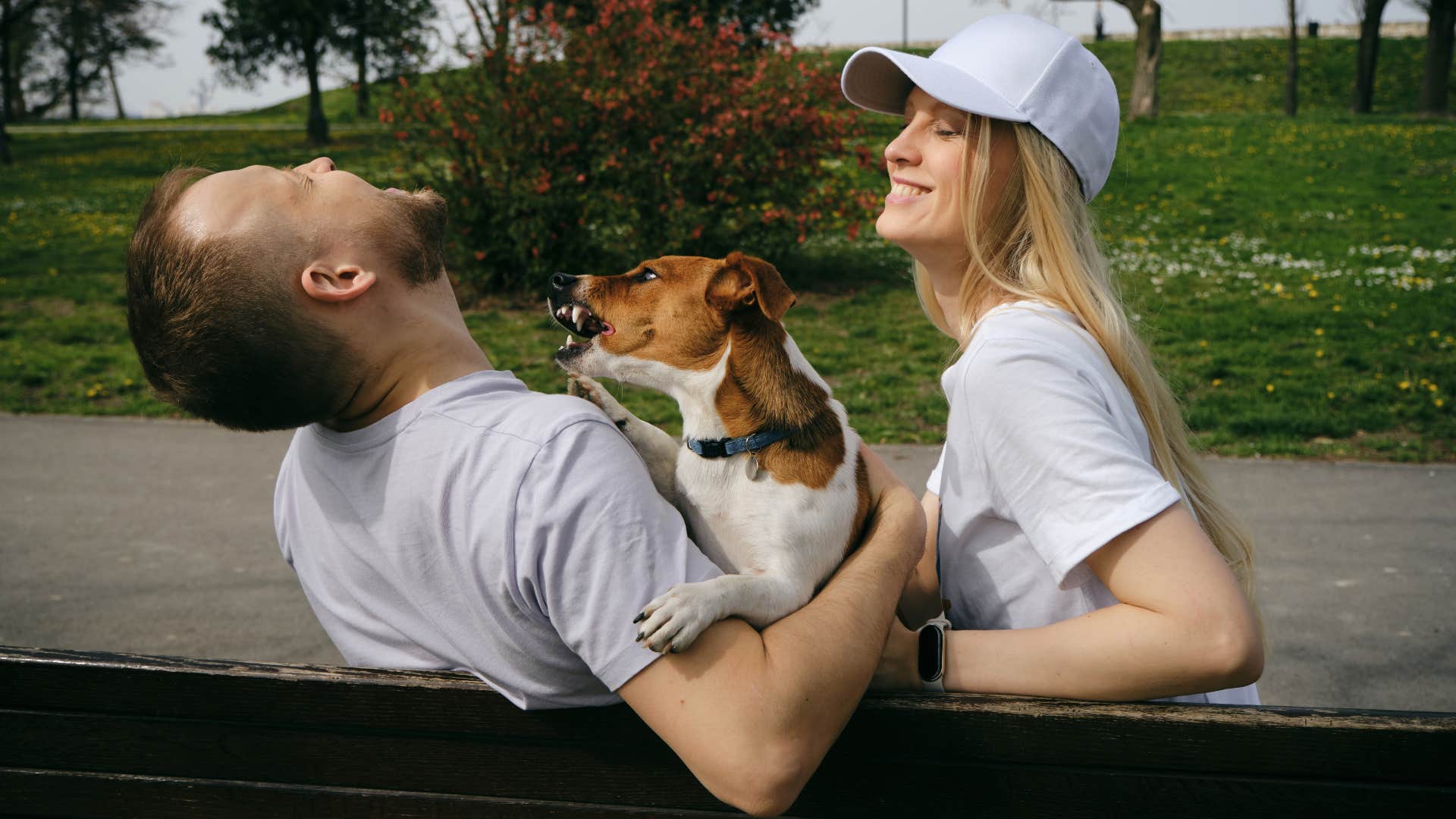 common mistakes that hurt your dog's feelings without you even realizing teasing them man and woman teasing dog annoying him