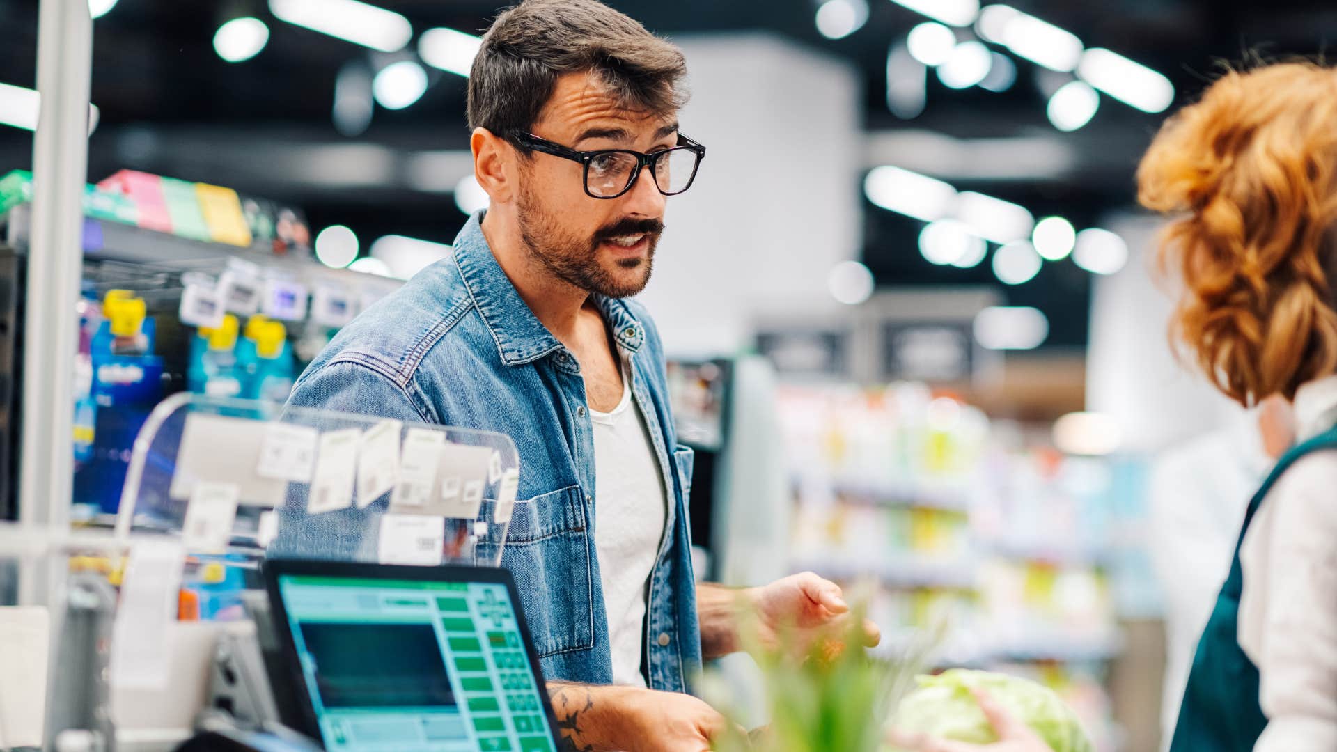 man telling woman at cashier actually and being rude