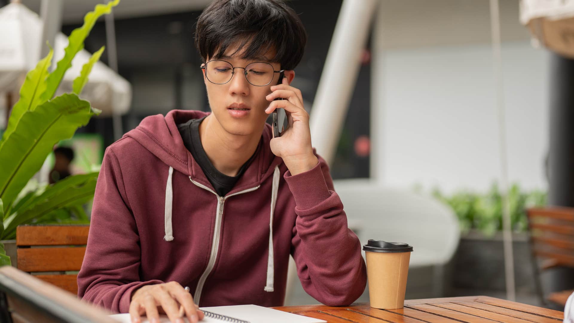 man talking to parents on the phone about adulting