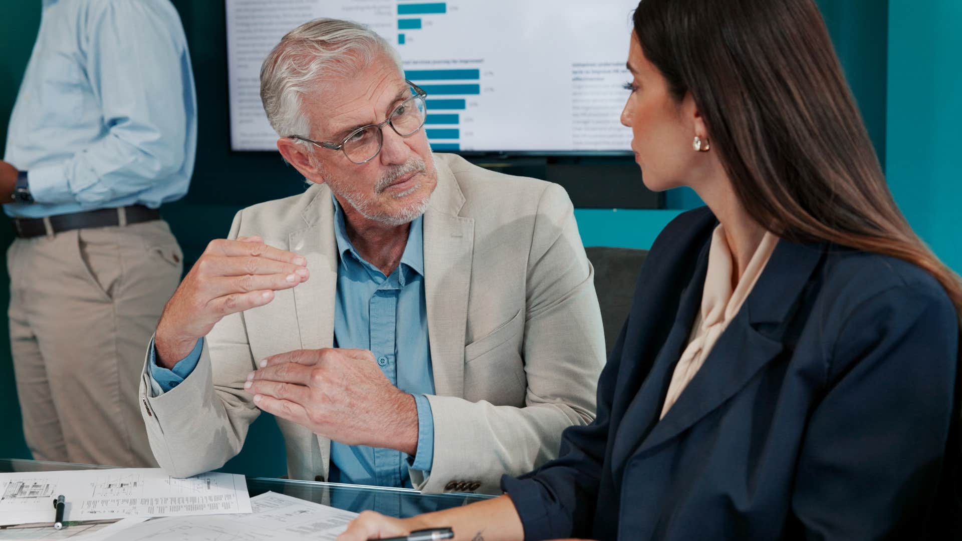 frustrated man talking to colleague