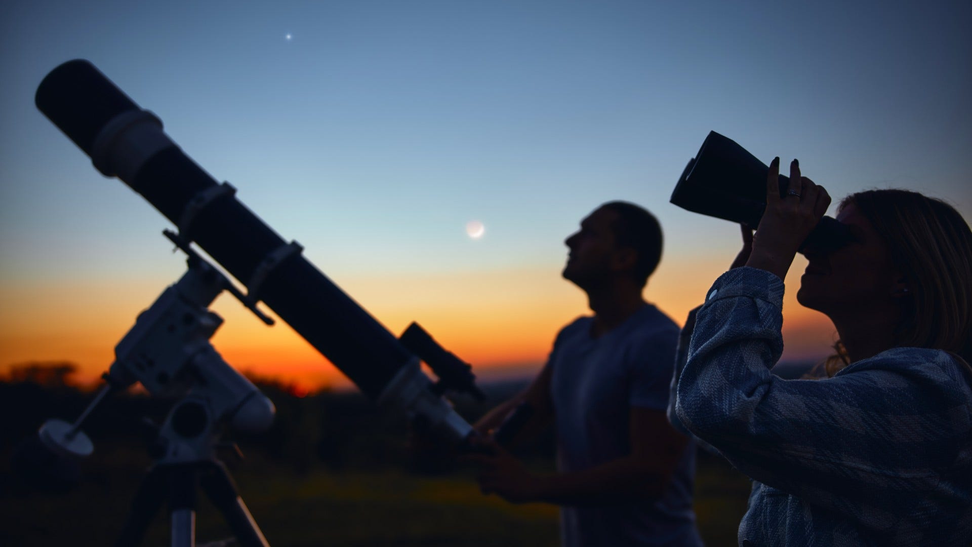 couple who are too tired to travel as they stargaze