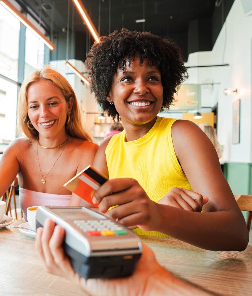 woman paying for friend