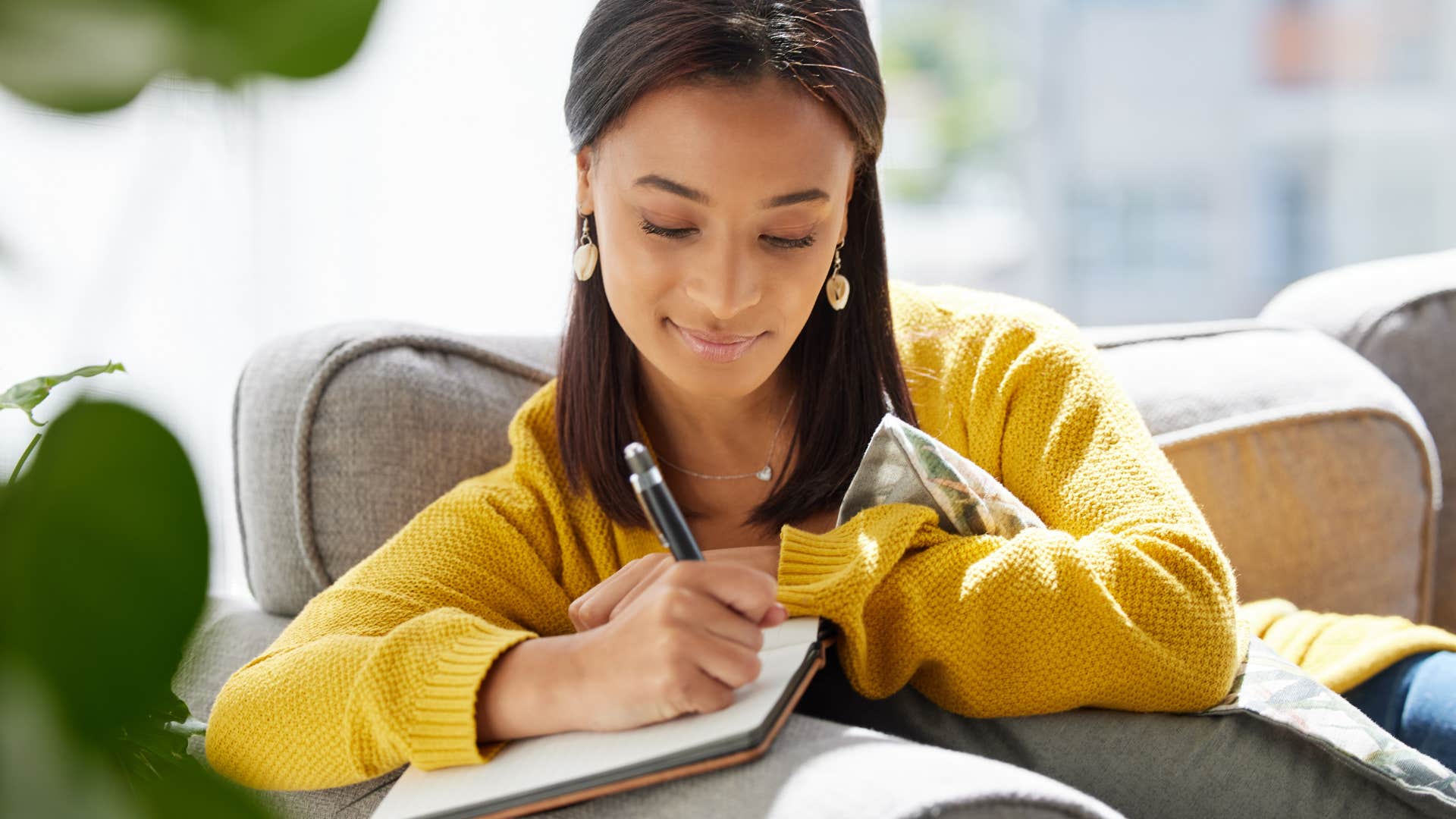 woman who keeps bad energy out of life by writing it down