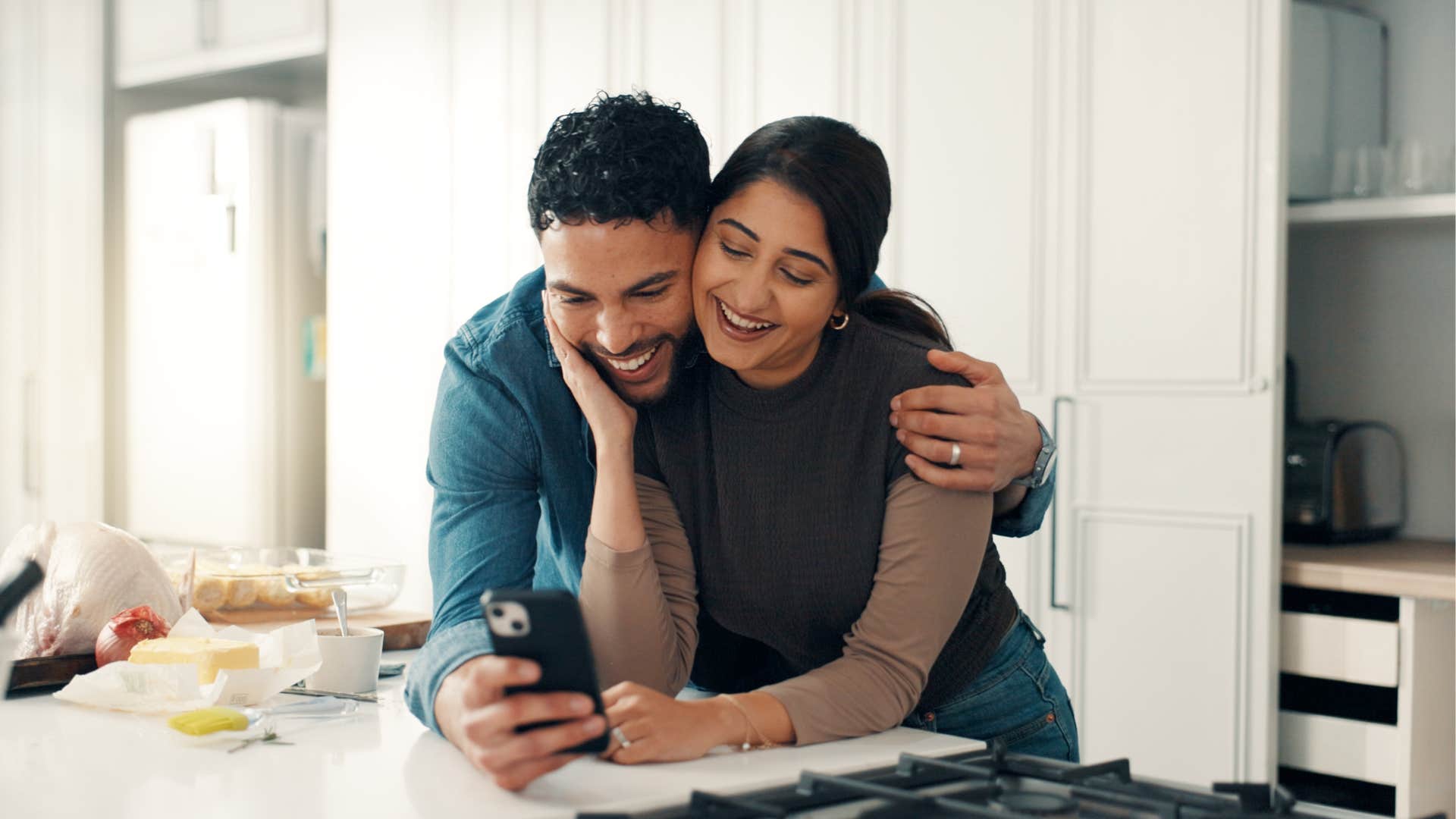 deeply in love people almost always send these text during casual conversation my heart feels so full when I'm with you couple hugging in the kitchen