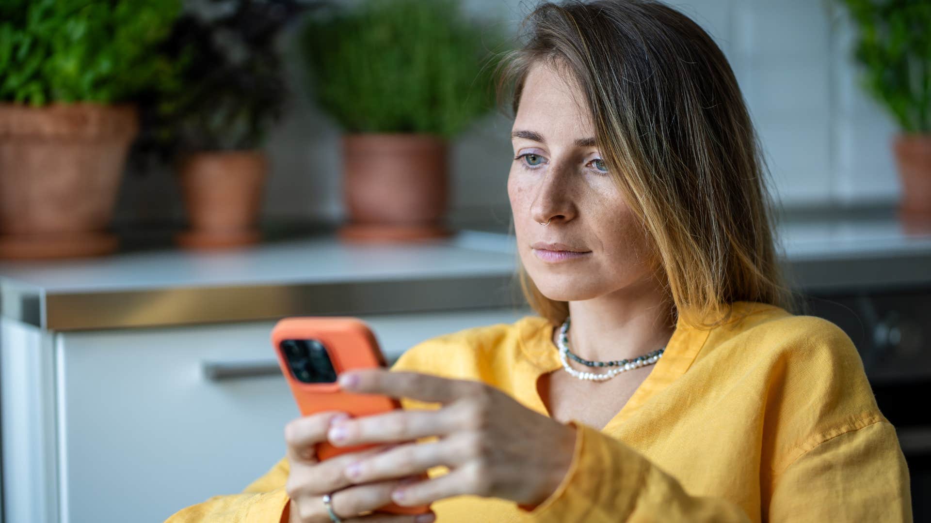 Woman texting "I don't care" on her phone.