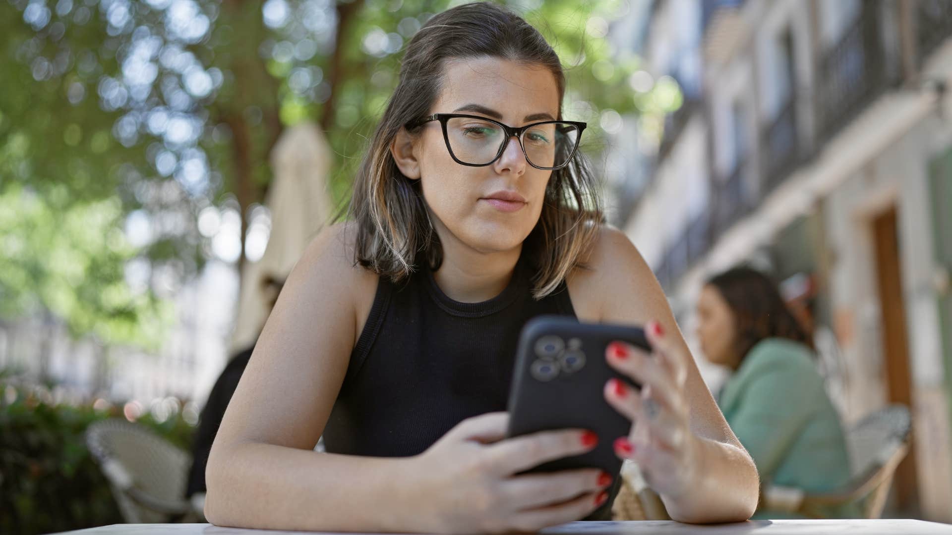 Woman texting "noted" on her phone.